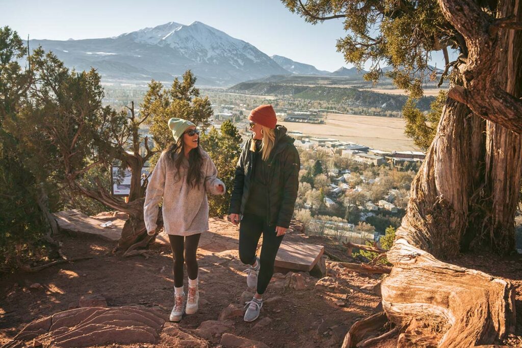 Two women walking on a mountain trail
